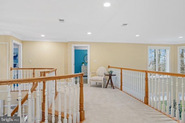 corridor with light colored carpet and ornamental molding