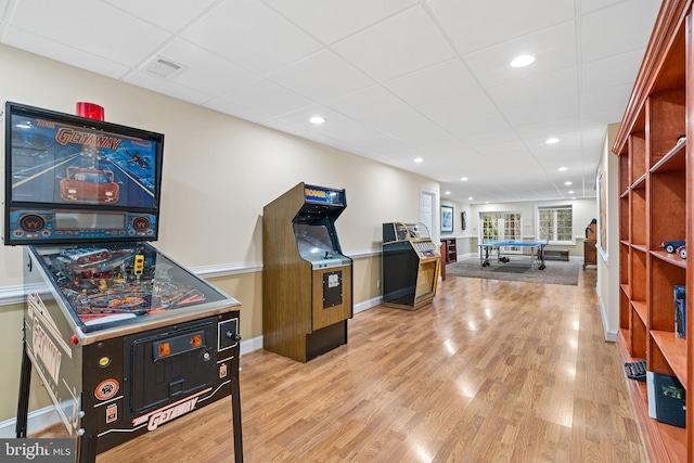 rec room featuring a paneled ceiling and light hardwood / wood-style flooring