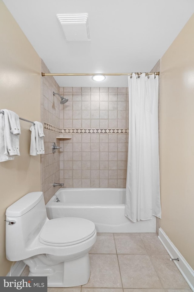 bathroom with shower / bath combination with curtain, tile patterned floors, and toilet