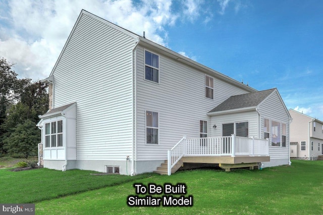 rear view of property with a deck and a yard