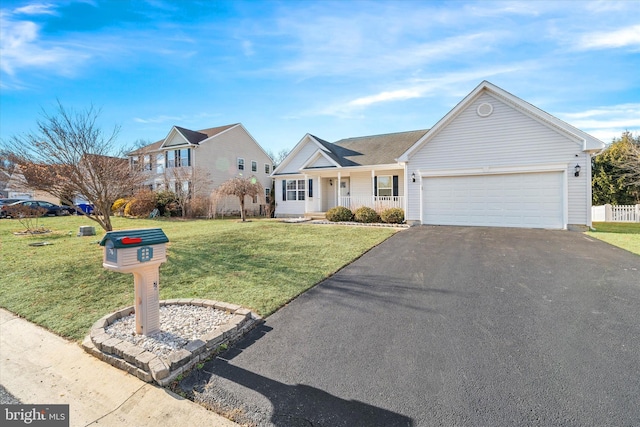 ranch-style home featuring a garage, covered porch, and a front lawn