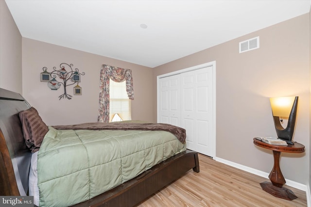 bedroom with hardwood / wood-style floors and a closet