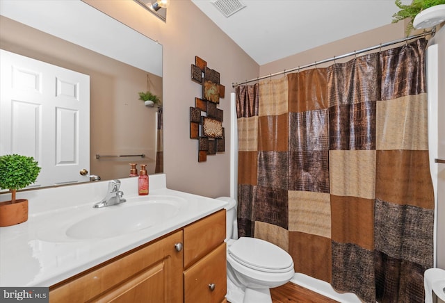 bathroom featuring a shower with curtain, vanity, and toilet