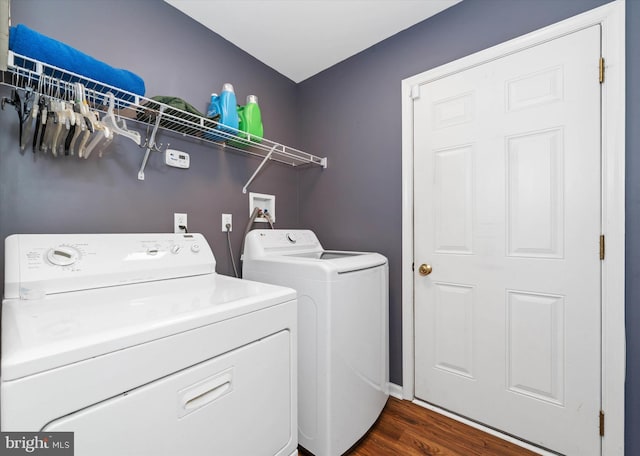 clothes washing area featuring dark hardwood / wood-style flooring and washing machine and dryer