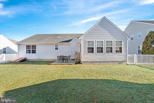 back of house with a lawn and a deck