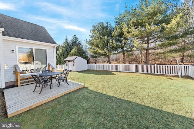 view of yard featuring a storage shed and a deck