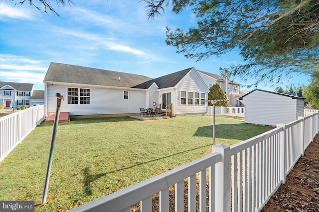 rear view of house featuring a yard and a patio area