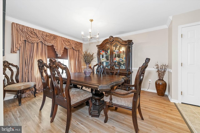 dining room with crown molding, wood-type flooring, and a chandelier