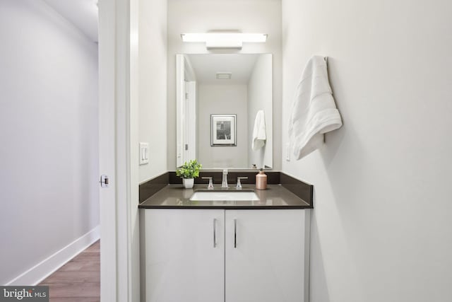 bathroom featuring hardwood / wood-style flooring and vanity