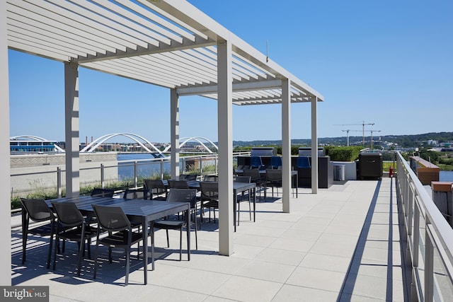 view of patio / terrace featuring a water view and a pergola