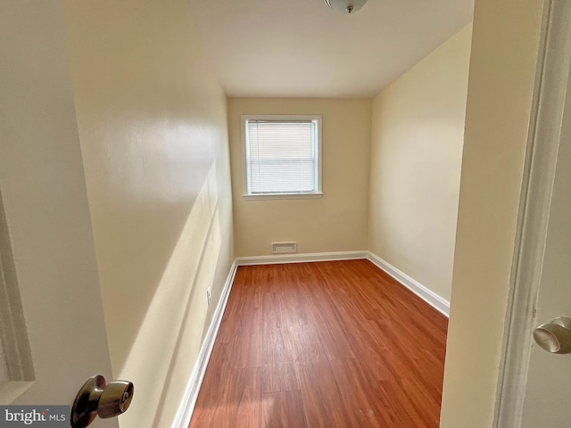 unfurnished room with hardwood / wood-style flooring