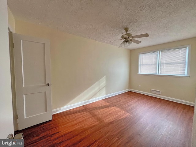 unfurnished room featuring ceiling fan, hardwood / wood-style floors, and a textured ceiling