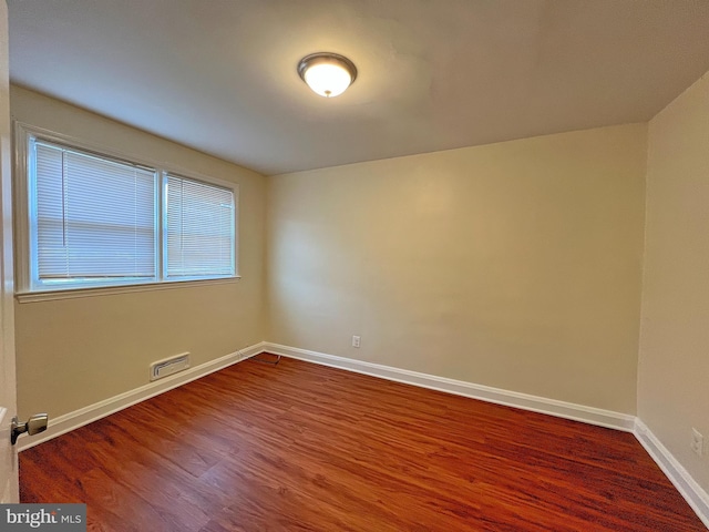 spare room with hardwood / wood-style floors