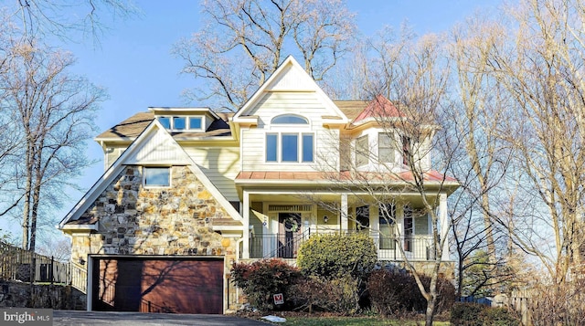 view of front of house featuring a garage and a porch