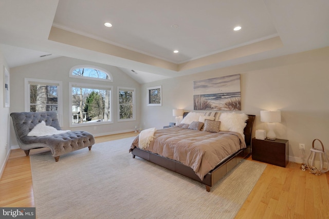 bedroom with vaulted ceiling and light wood-type flooring