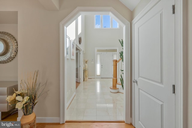 hall with light tile patterned floors