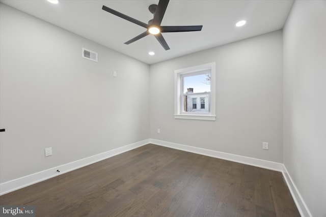 unfurnished room with ceiling fan and dark hardwood / wood-style flooring