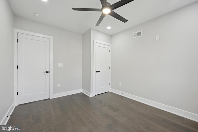 spare room with ceiling fan and dark hardwood / wood-style flooring