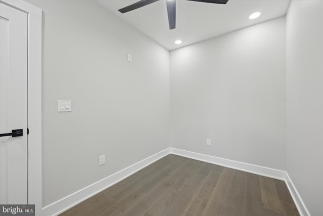 unfurnished room featuring dark wood-type flooring and ceiling fan