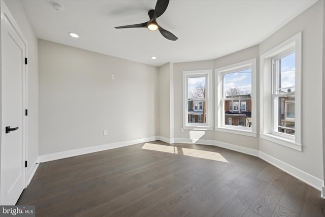 empty room featuring dark wood-type flooring and ceiling fan