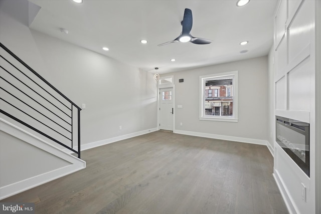 unfurnished living room with ceiling fan and hardwood / wood-style floors