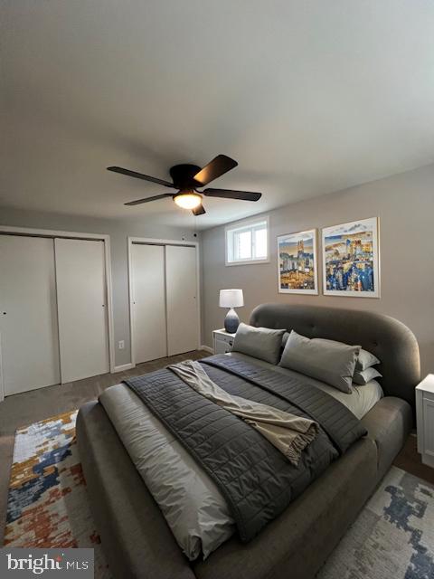 bedroom with two closets and ceiling fan