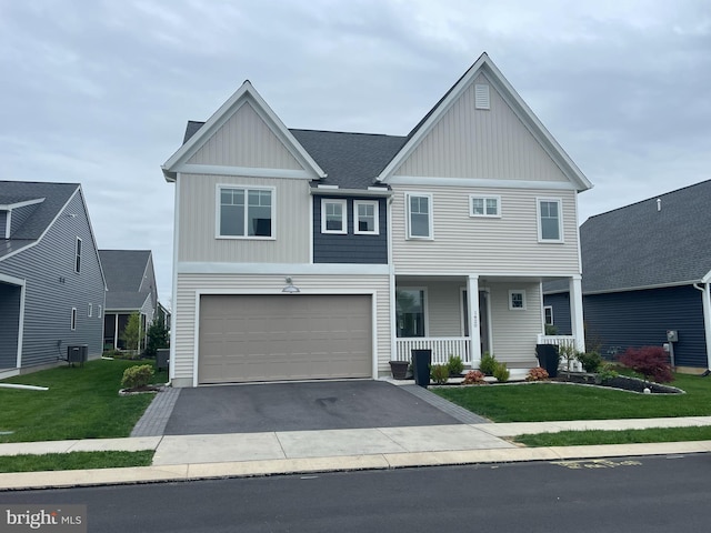 view of front of house featuring central AC, a porch, a garage, and a front yard