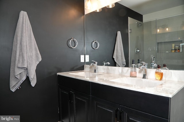 bathroom featuring double vanity, a sink, and tiled shower