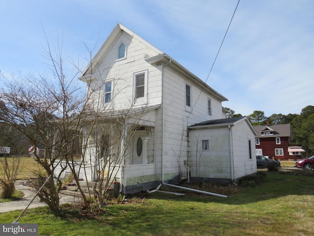 view of side of property with a lawn