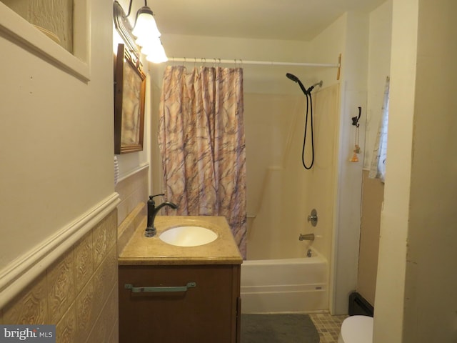 full bathroom featuring vanity, shower / bath combination with curtain, and toilet