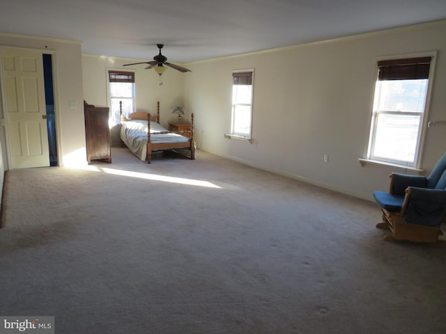 unfurnished bedroom featuring ceiling fan, light colored carpet, and ornamental molding