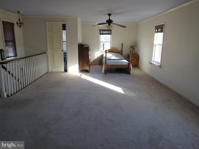 unfurnished bedroom with ceiling fan, ornamental molding, and light carpet