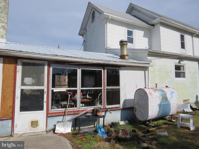 back of property with a sunroom