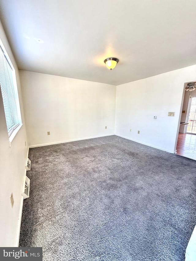 carpeted spare room with an AC wall unit