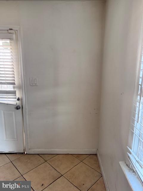 doorway with light tile patterned flooring