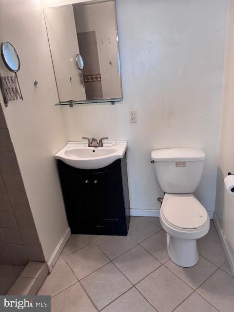 bathroom featuring tile patterned flooring, vanity, and toilet