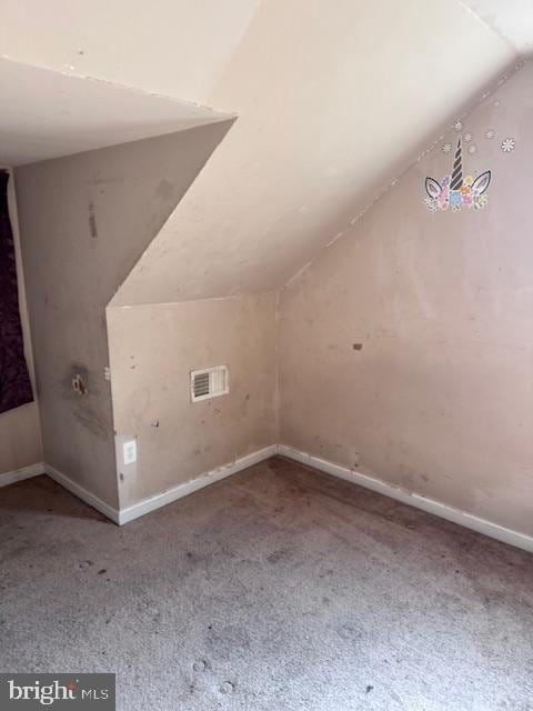 additional living space featuring lofted ceiling