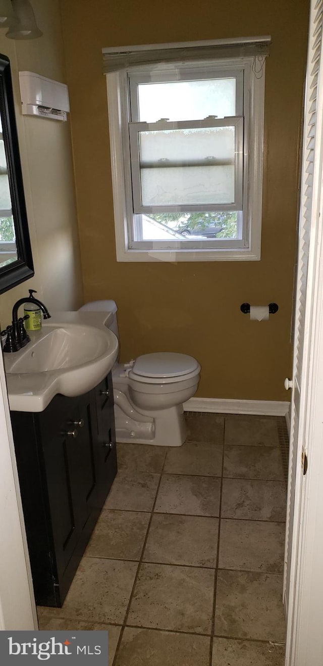 bathroom with vanity, tile patterned floors, and toilet