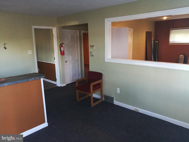 interior space with dark colored carpet