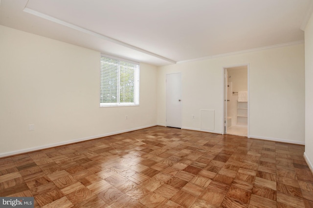 spare room with ornamental molding and parquet flooring