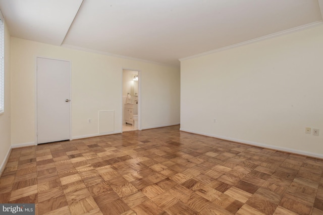 unfurnished room featuring light parquet floors and crown molding