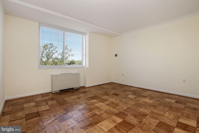 unfurnished room featuring radiator, crown molding, and parquet flooring