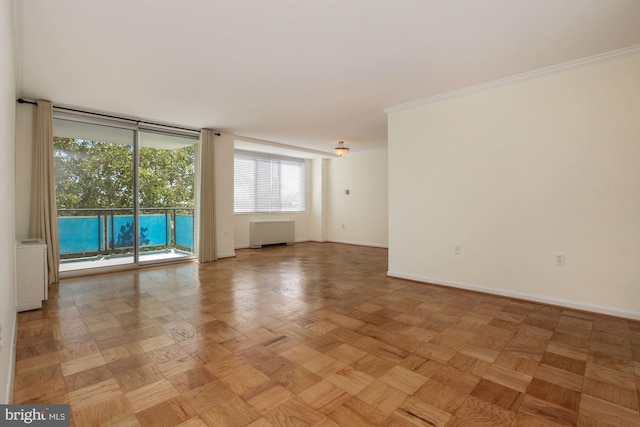 unfurnished room featuring crown molding, radiator, and light parquet floors