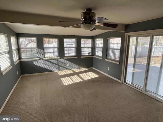 unfurnished sunroom featuring lofted ceiling, a wealth of natural light, and ceiling fan