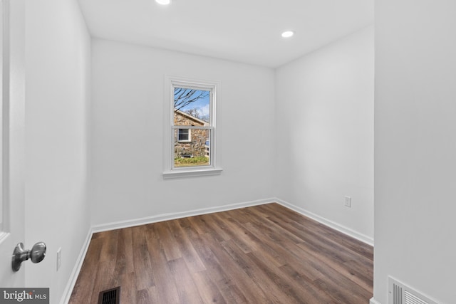 spare room featuring dark hardwood / wood-style floors