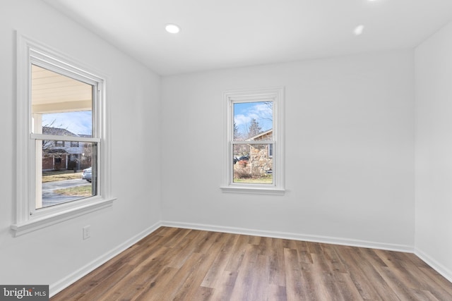 unfurnished room featuring hardwood / wood-style flooring