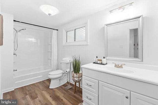 full bathroom featuring vanity, hardwood / wood-style floors, shower / tub combo with curtain, and toilet