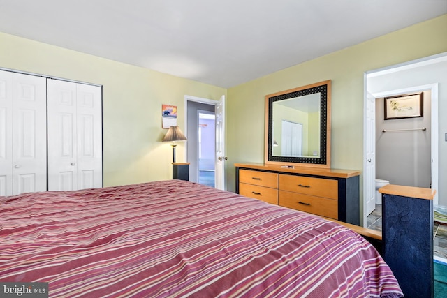 bedroom featuring ensuite bathroom and a closet