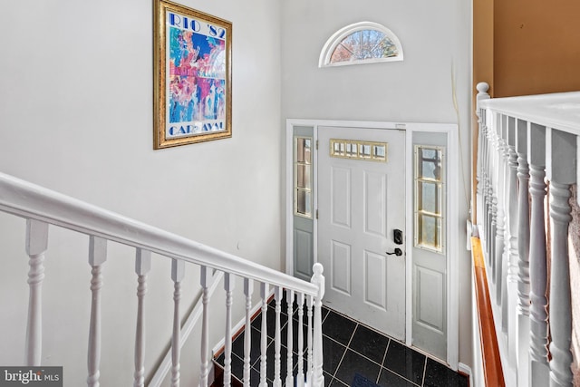 foyer entrance featuring dark tile patterned flooring