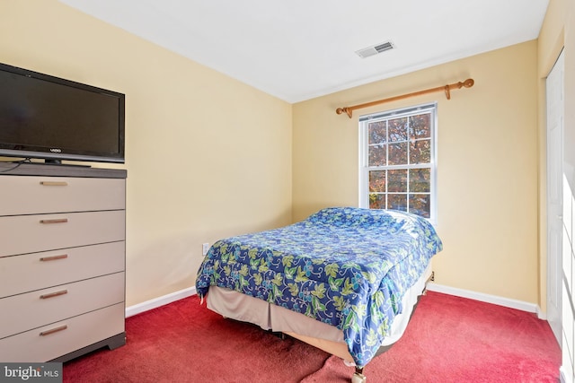 bedroom with dark colored carpet